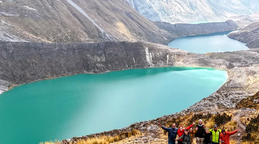 Panoramic view of three turquoise lakes from the Three Lakes viewpoint in the Huayhuash Range, Peru